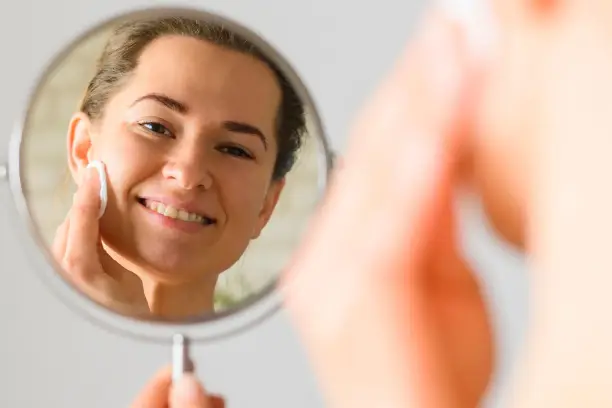 front view woman apply sunscreen on her face